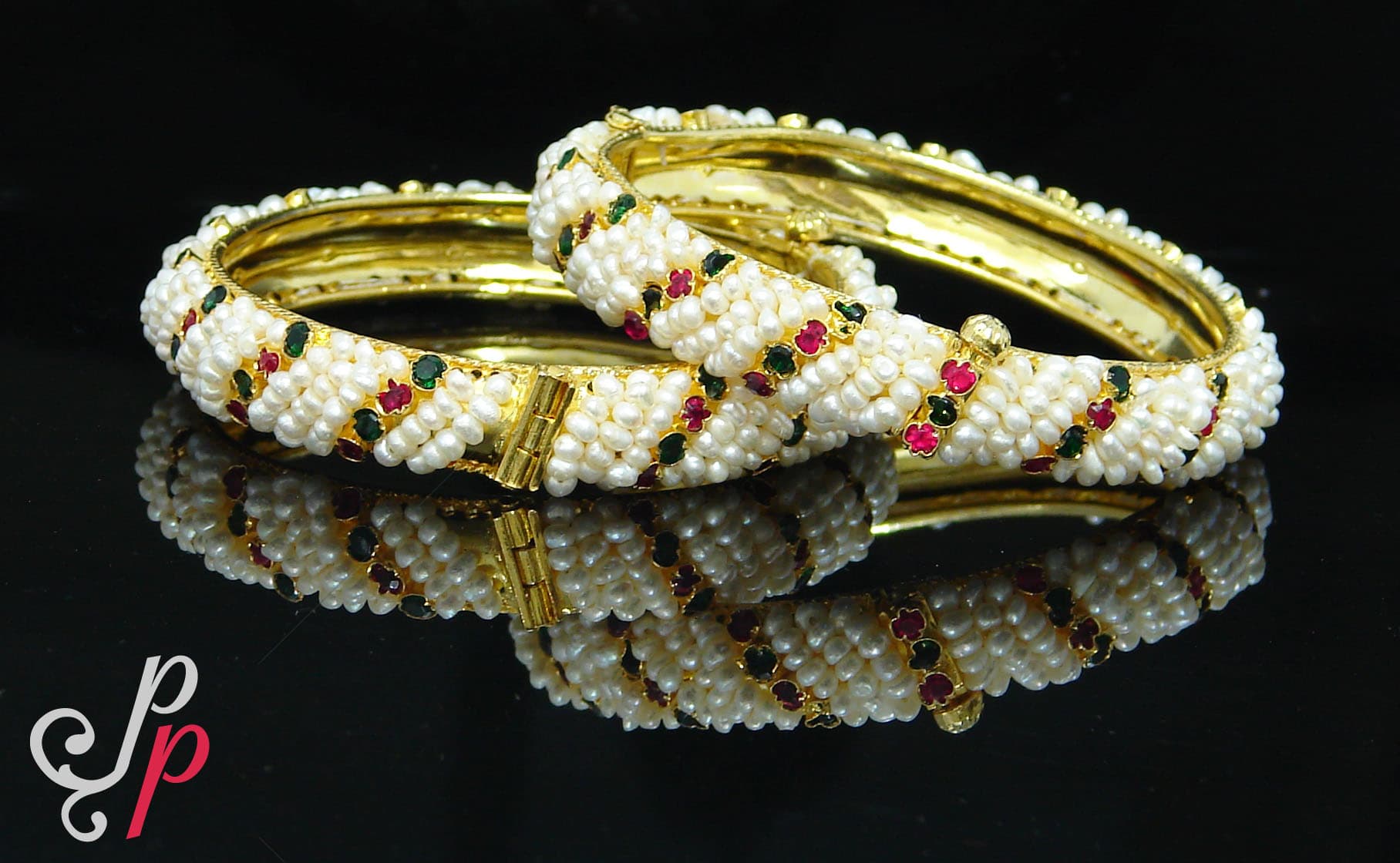 Traditional and elegant seed pearl bangles in red and green stones