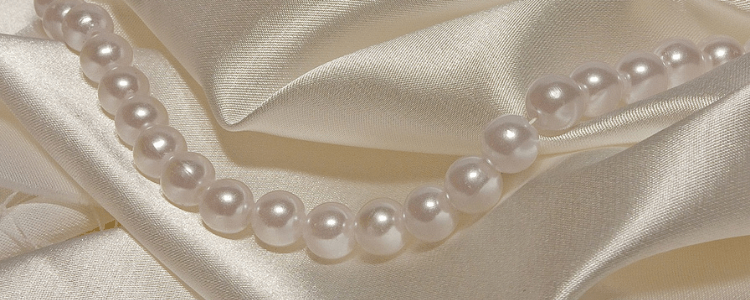 beautiful pure white pearls on satin cloth