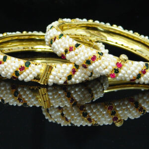 Traditional and elegant seed pearl bangles in red and green stones