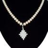 Superbly crafted semi-round pink pearl necklace set with a big diamond-shaped pendant with AD stones - close up