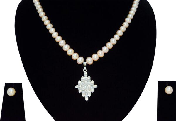 Superbly crafted semi-round pink pearl necklace set with a big diamond-shaped pendant with AD stones - close up