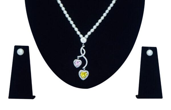 Well crafted oval white pearl necklace set with a zircon studded pendant with hearts - close up