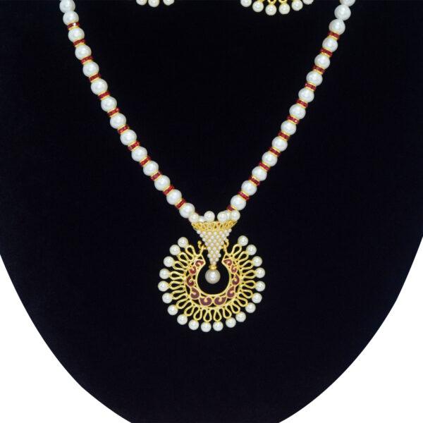 Well crafted white round pearls with SP ruby roundels and a captivating faux pearl pendant with red enamel - close up