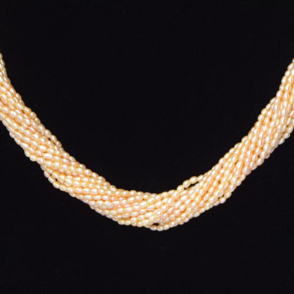 Stunning 15 strands of peach rice pearls finely crafted to a long 20-inch necklace - twisted close up