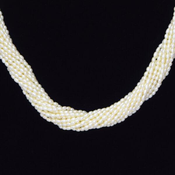 Elegantly well crafted 15 strands of peach rice pearls necklace that is 20 inches in length - close up