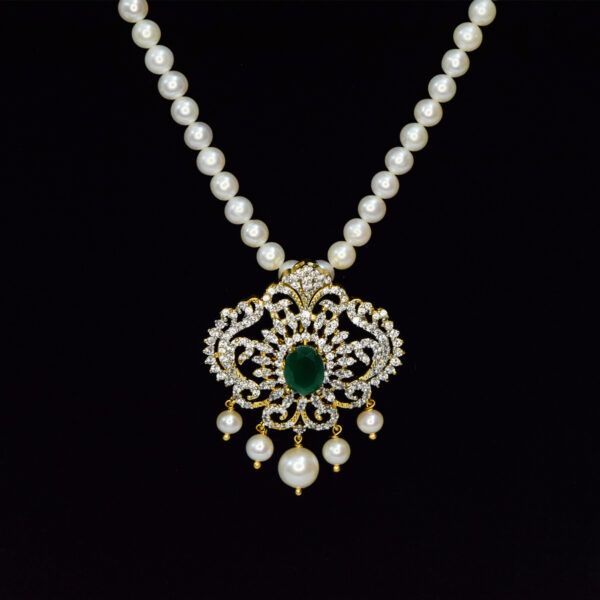 Bright 5mm round white pearls necklace with an artistic CZ studded peacock pendant with SP Emerald in the centre - close up