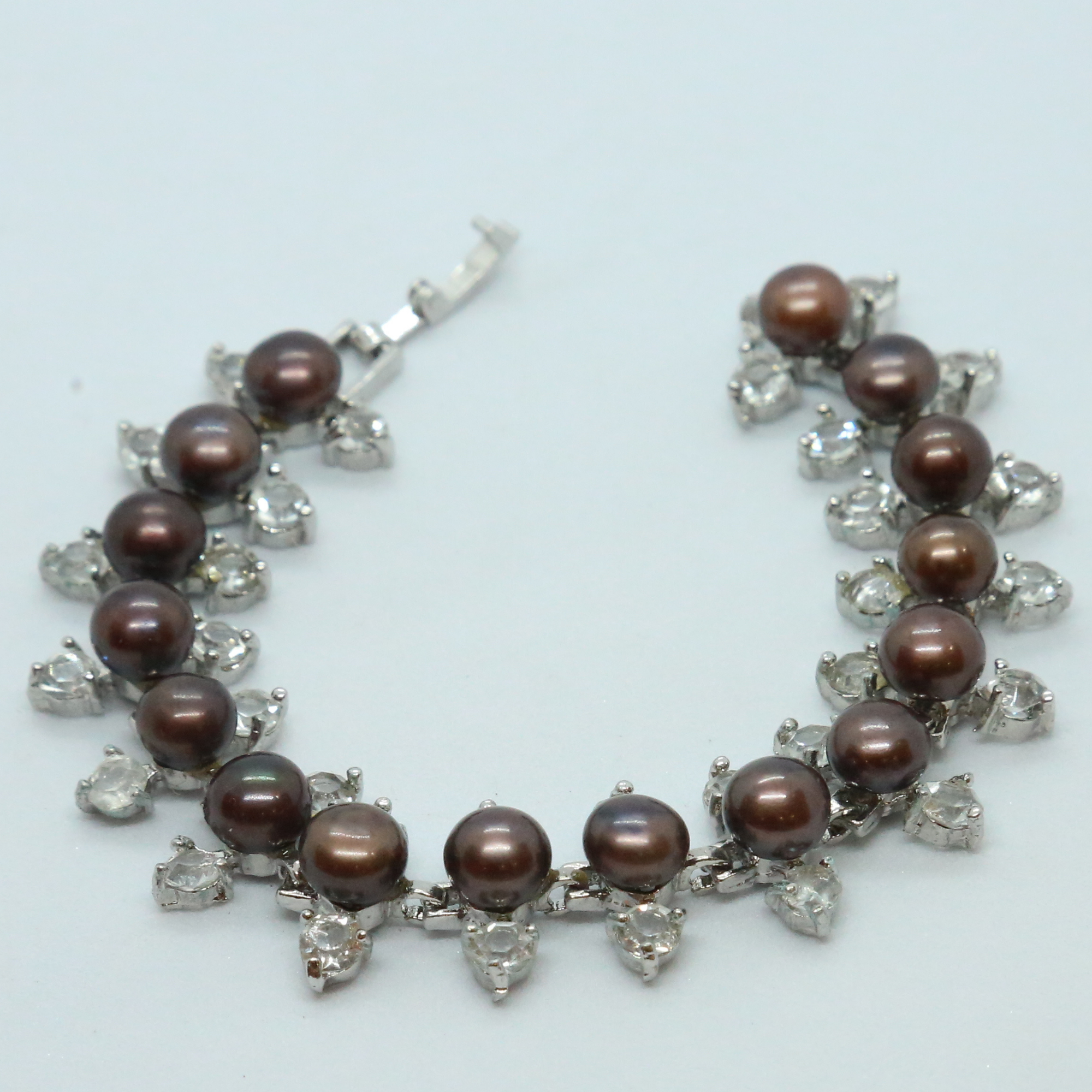 Regal Brown Button Pearls Bracelet With AD In Silver Finish